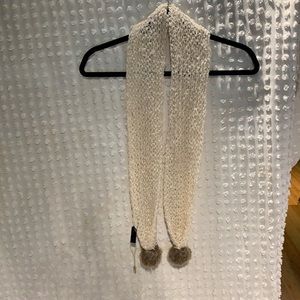 Beige knitted scarf with fuzzy ball ends